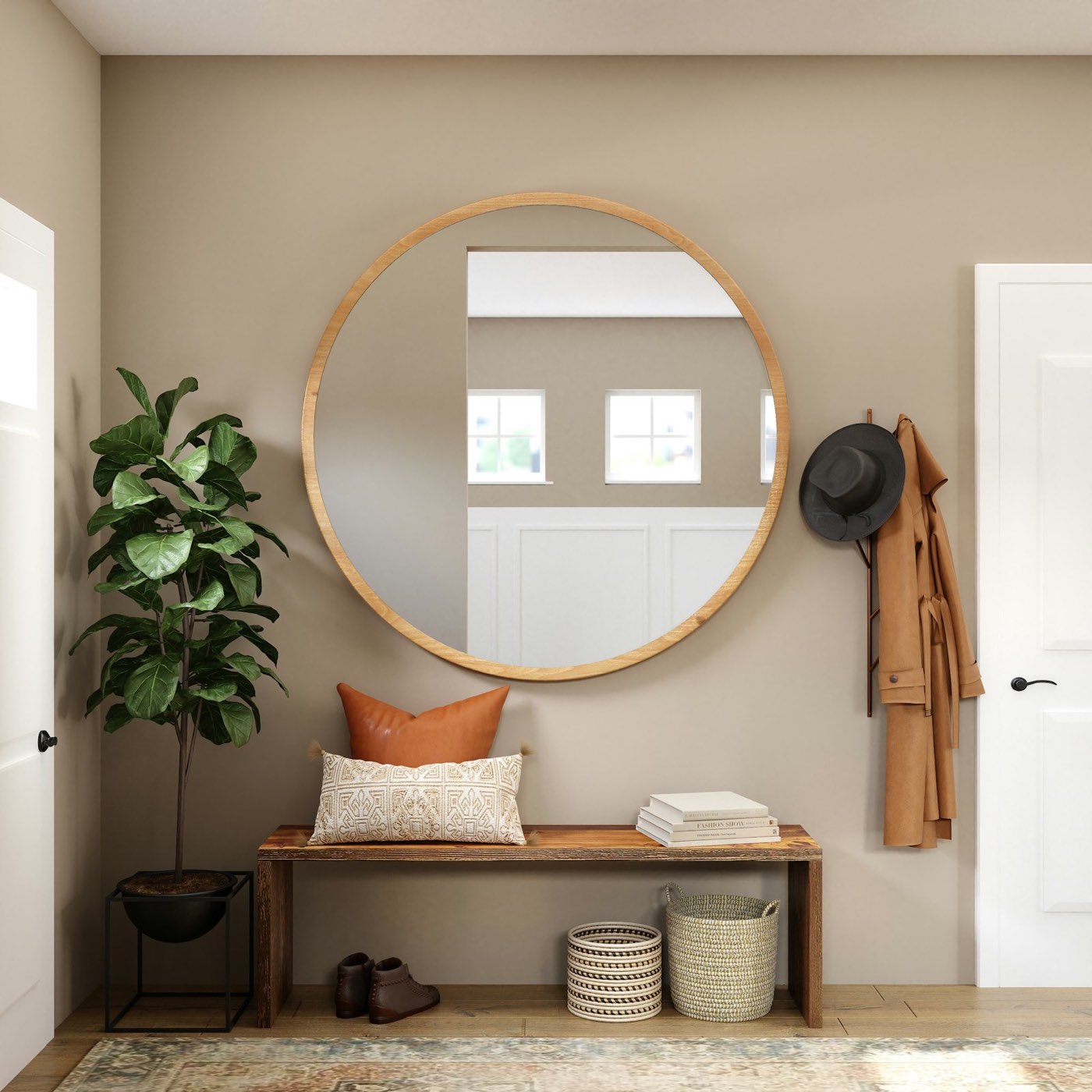 An entry with a round mirror, wall hooks, a small bench and a potted plant