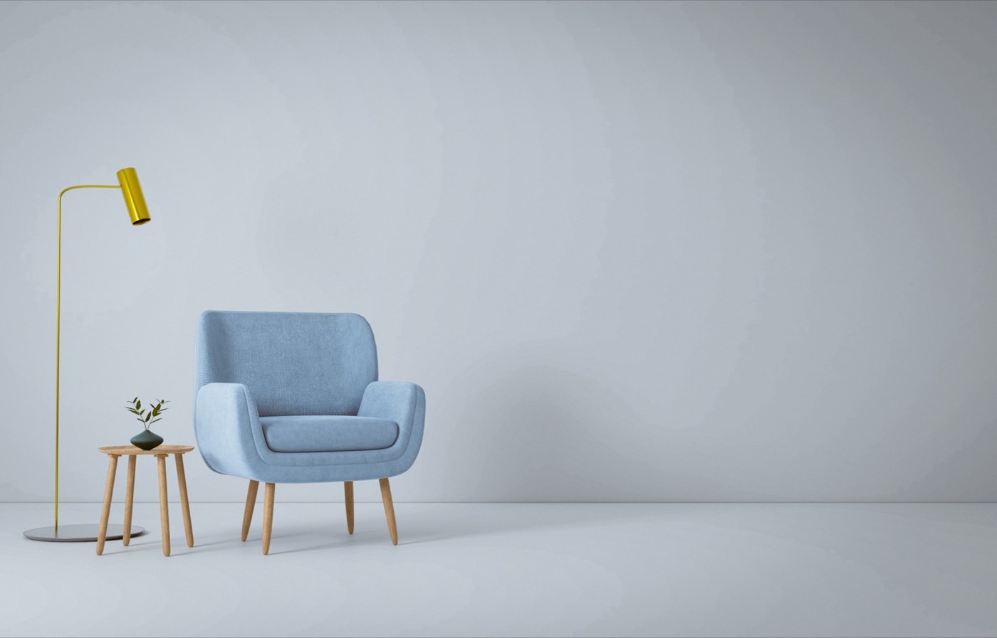A pale blue armchair and a small side table standing in an empty room